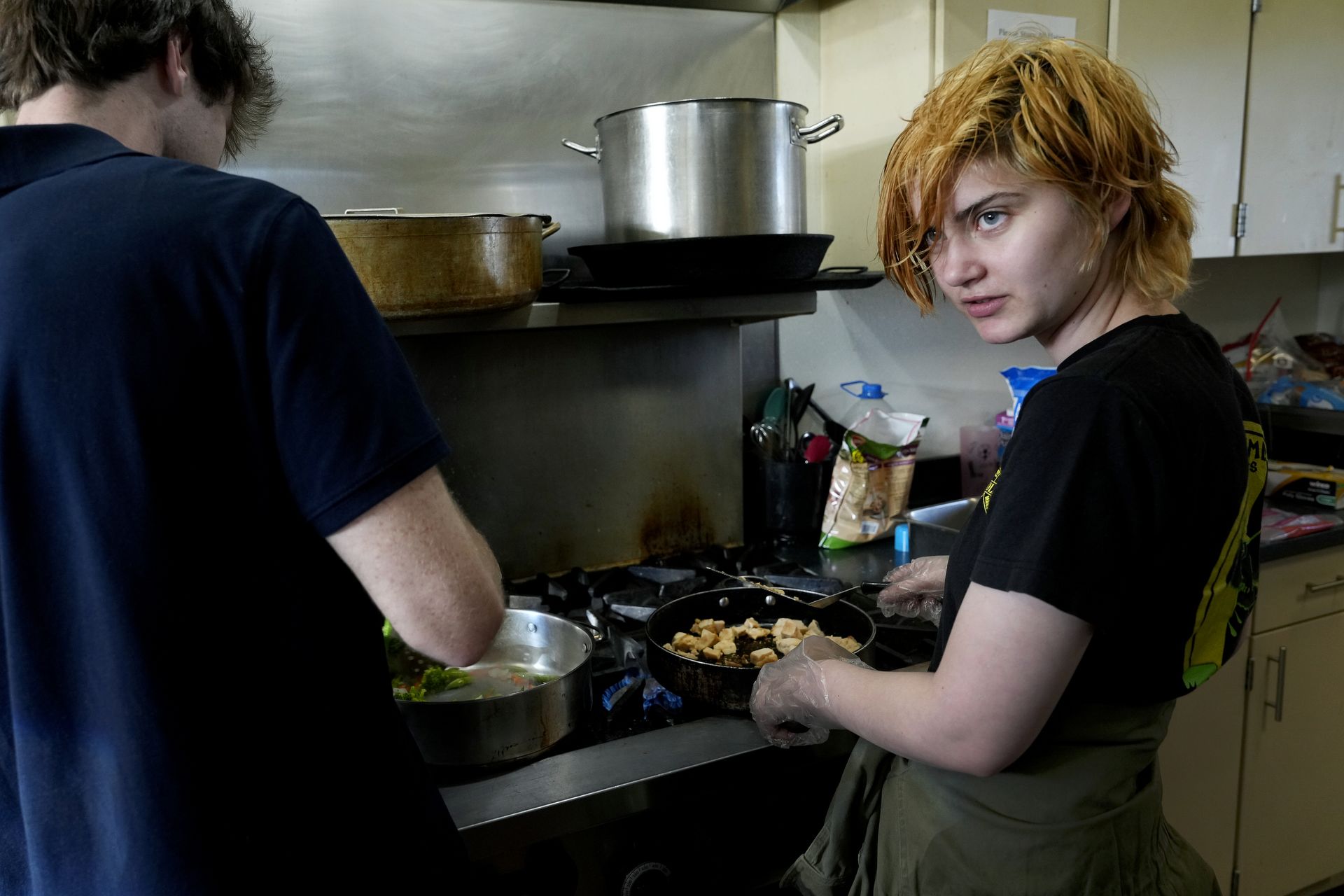 Student Raphael Sullivan helps prepare dinner on April 4 at The Place.