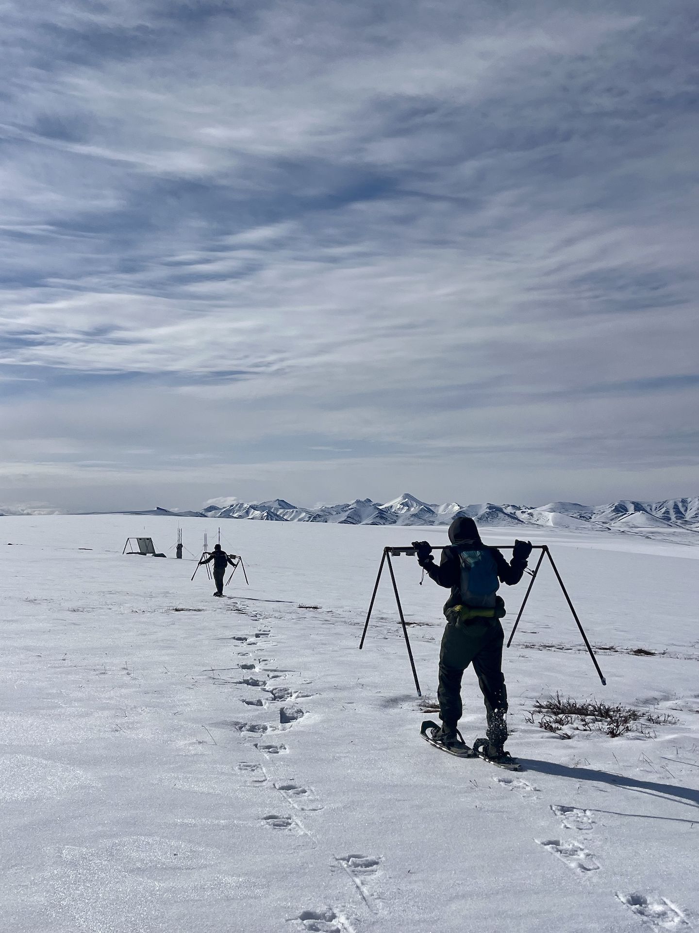 Ian Hauver-Radloff ’26 and Zach Ginn '23 using snowshoes to carry camera frames.