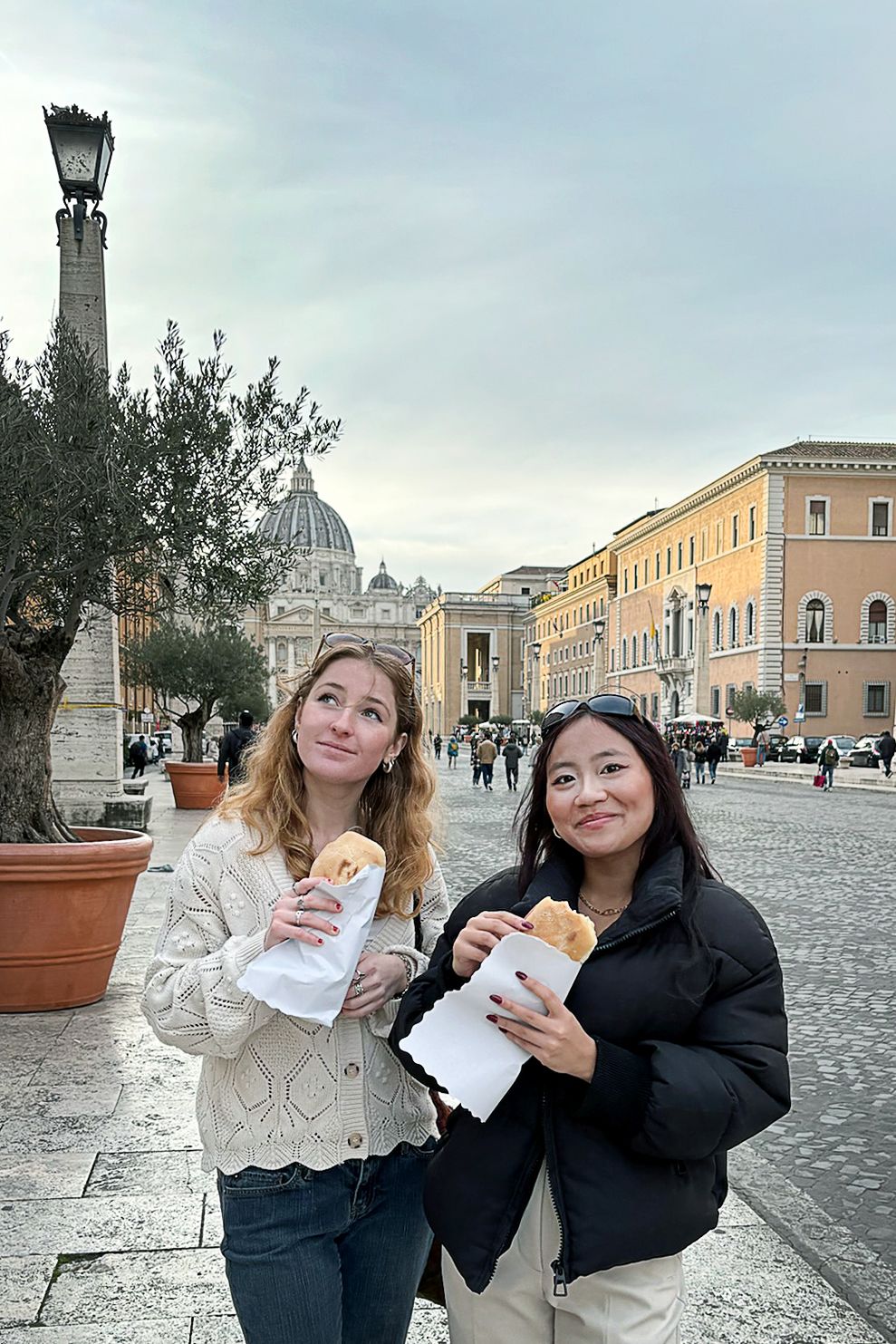 Cate Rosenbaum ’25 and Hope Shea '26 with their dinner after they saw Saint Peter’s Basilica. They took a tour of the basement there and saw where his bones are rumored to be, as well as graffiti from pilgrims from the year 300 AD.