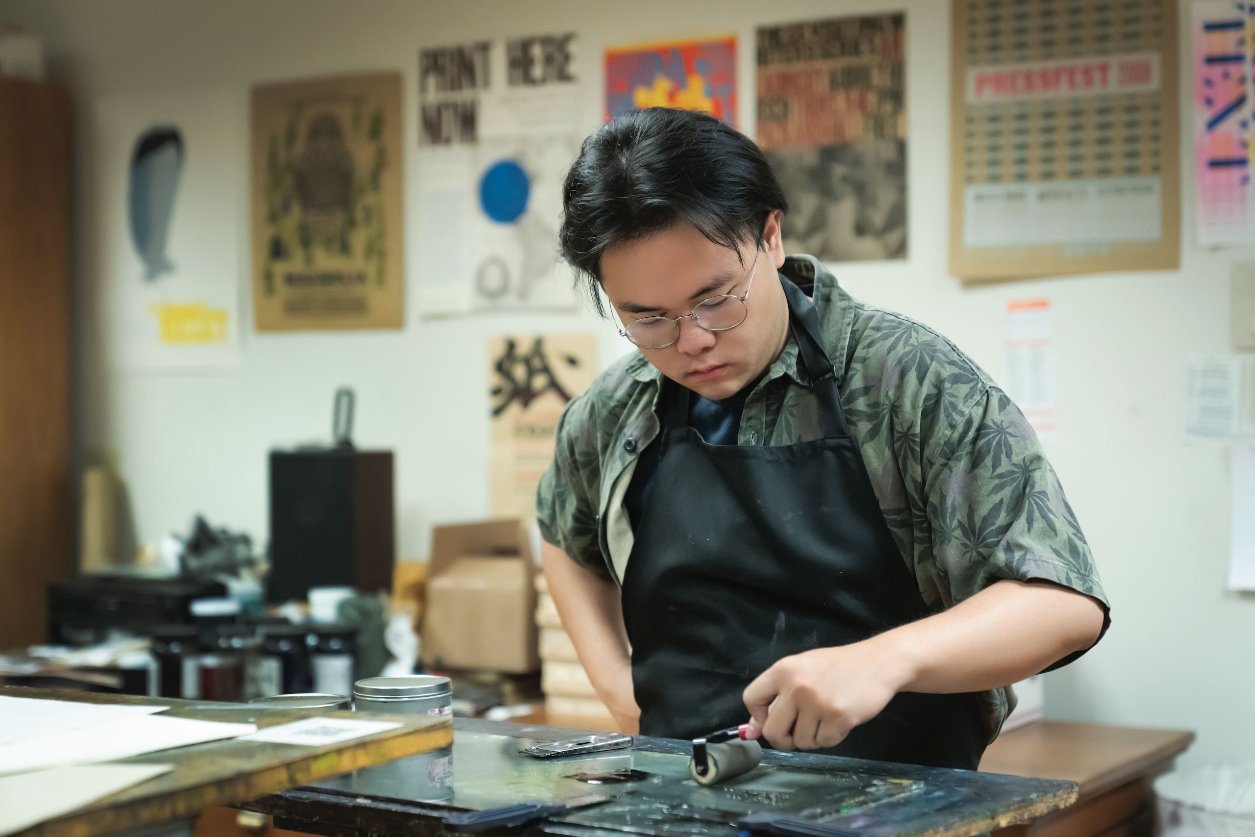 Letterpress student setting type in the letterpress studio