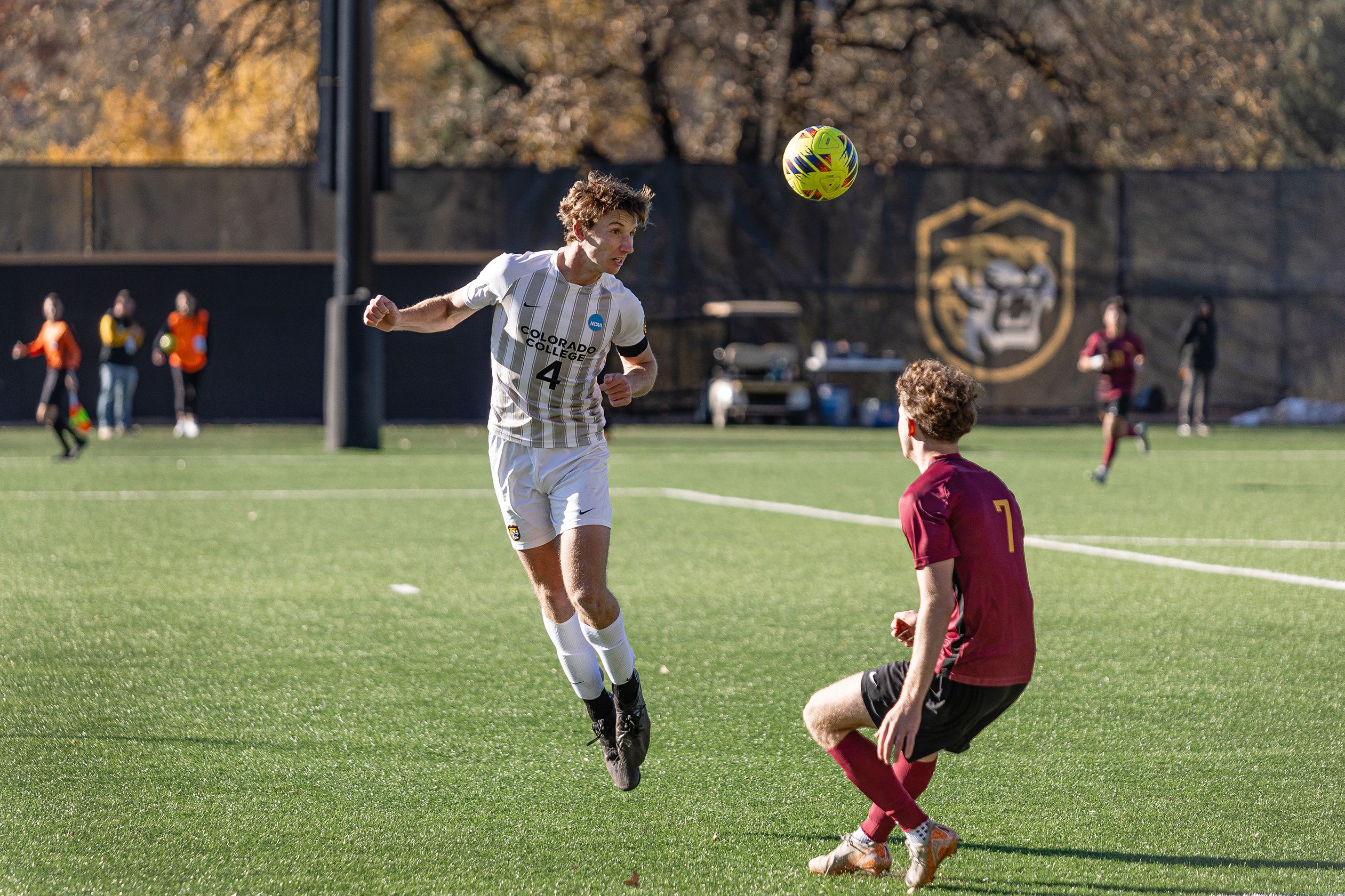 Colorado College men's soccer player jumping up for a header