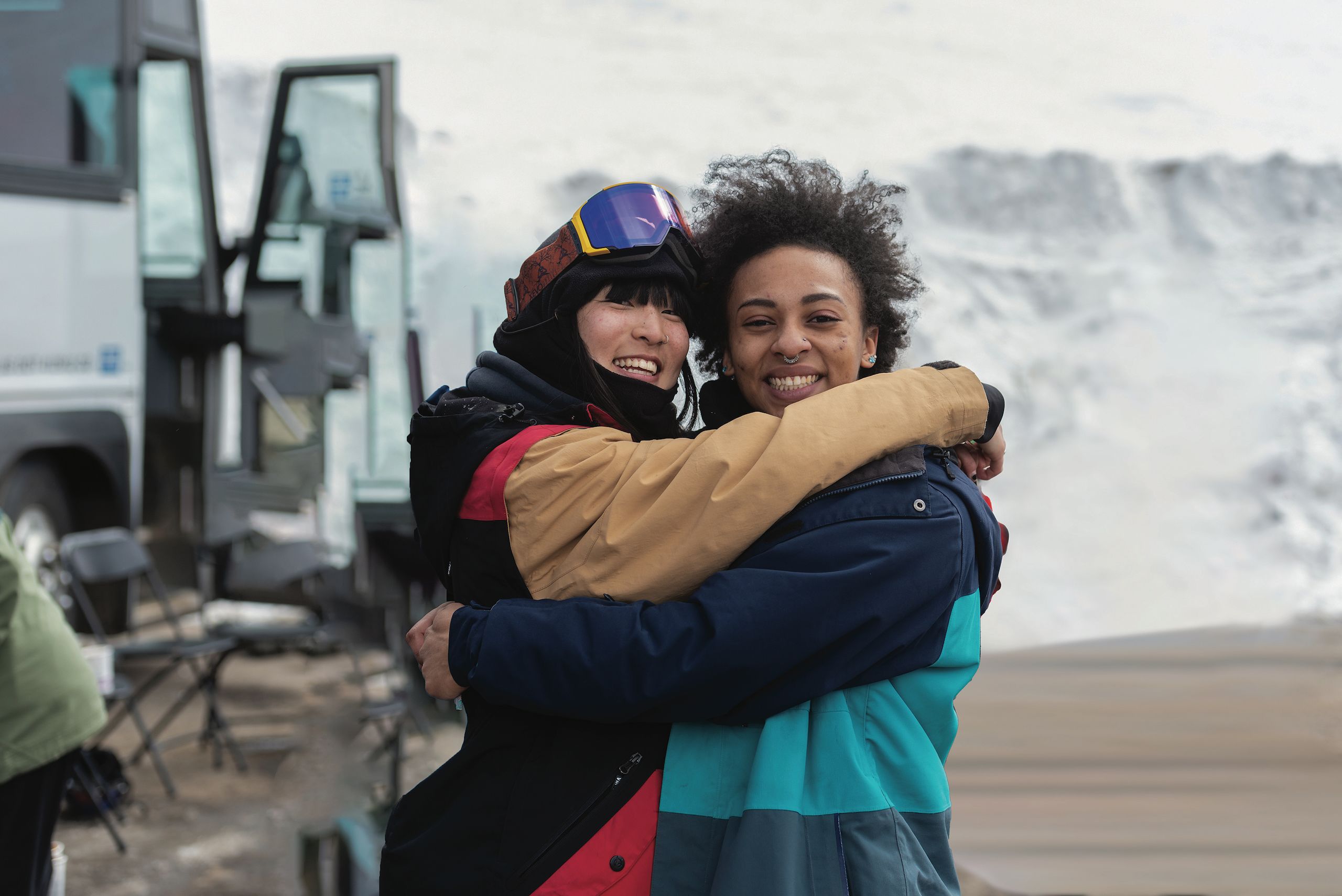 Amy Raymond '21 (left) and Sally Hedderman '21 (right) hugging each other dressed in winter gear during Colorado College's Outdoor Education  Snow Day, an opportunity for students who are new to winter sports to spend a day learning to ski/snowboard.