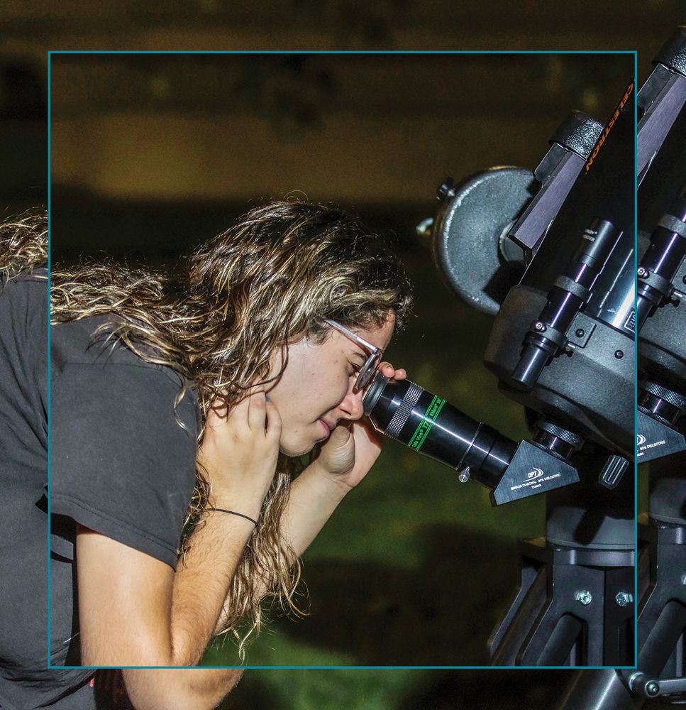 A CC student takes a closer look at the night sky during a skywatching party hosted by Dhanesh Krishnarao and Austin Hinkel for their Astronomy class.