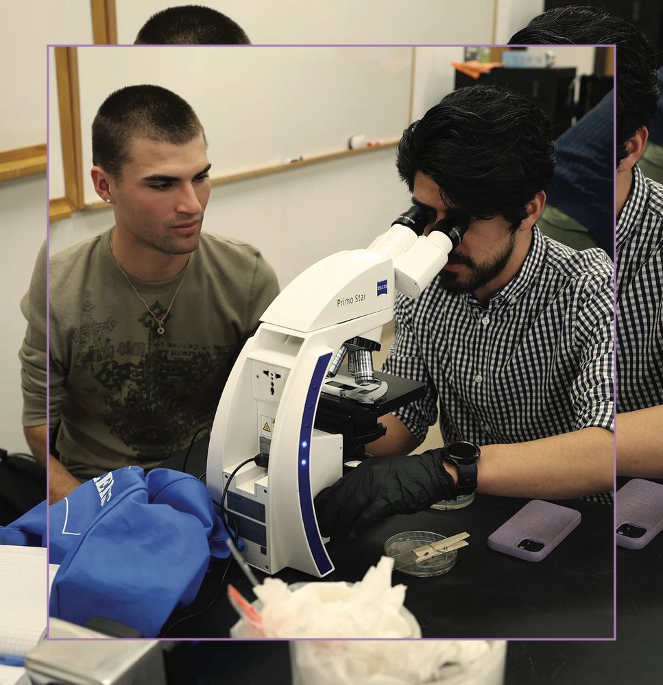 Dr. Jesús Peña teaches BE107 Biology of Microbes for a group of students who perform the Gram stain technique and use microscopy to learn about bacteria.