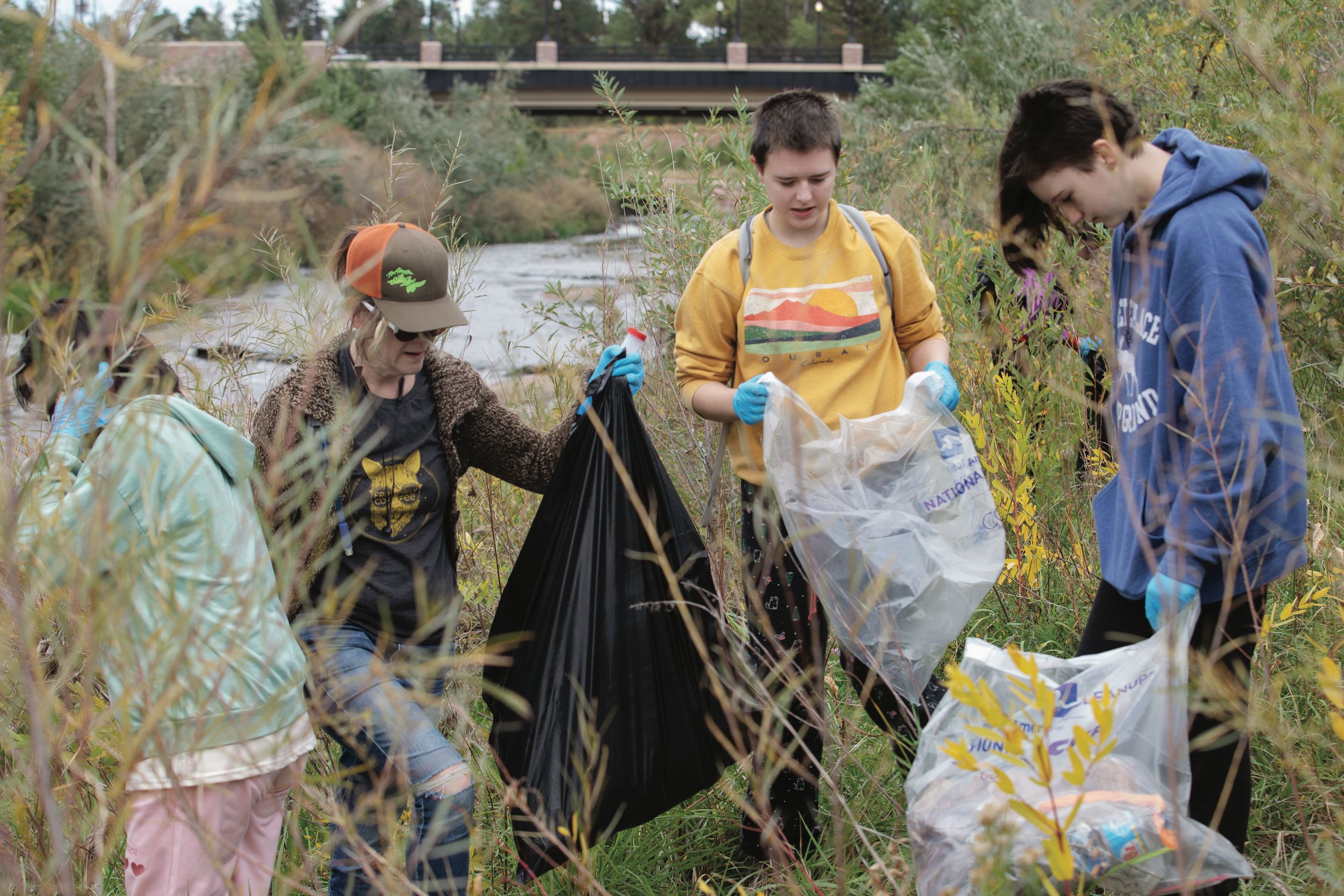 Students picking up trash along Monument Creek.