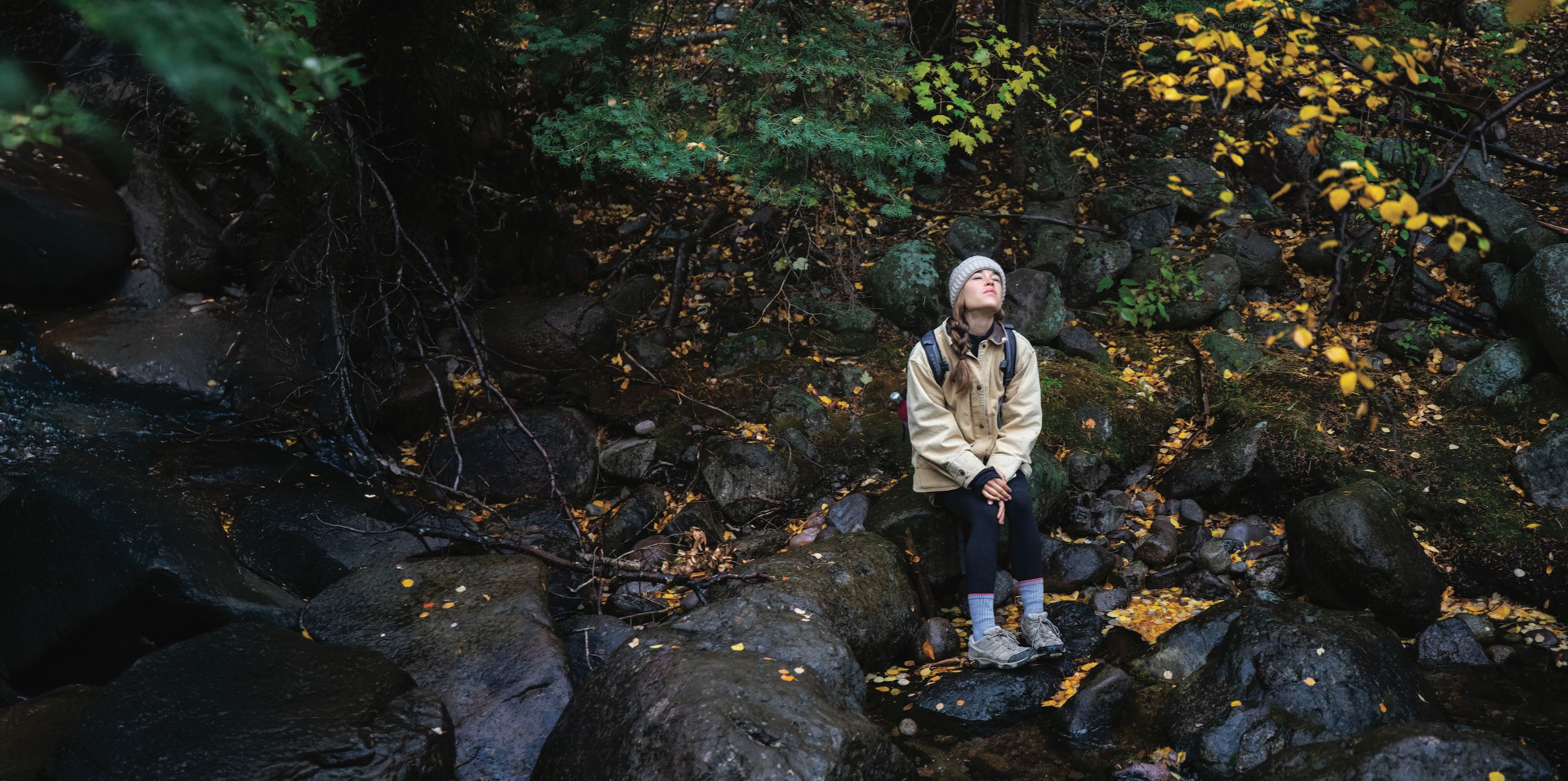 Emily Dwyer focuses on the sounds of the forest and stream near Crestone Trail as a part of a lesson on the effects people can have on nature if they focus on gratitude.