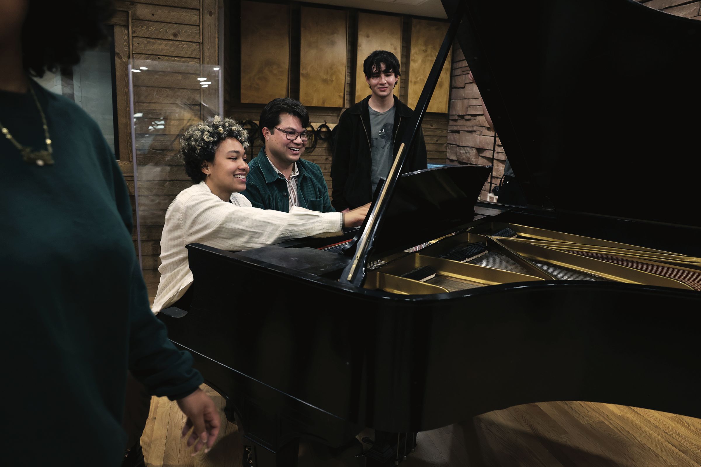 Ryan Bañagale, Chair of Music at Colorado College and Director of the Crown Center for Teaching, sings and plays piano with a group of students he’s taught, either for their majors or minors, in the recording studio at Packard Hall. Iyanla Ayite ’25, Music major, at piano, and Connor Chen ’25, right, Business, Economics, and Society major.